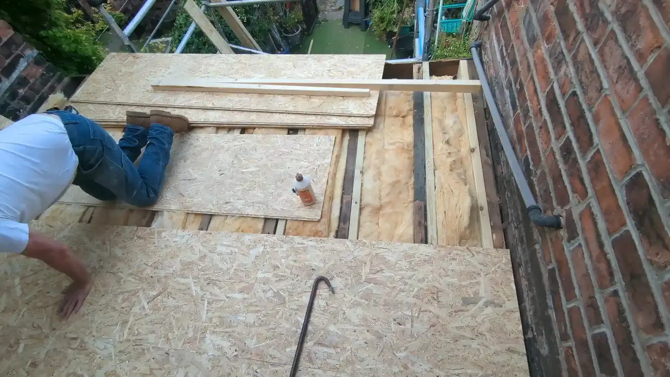 Installing OSB boarding over the repaired flat roof structure
