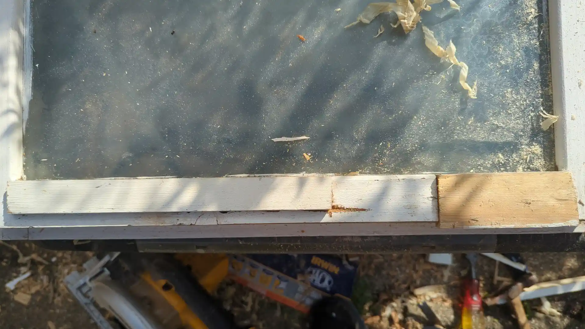 New timber let into the bottom rail of a casement window beside the retained original painted timber