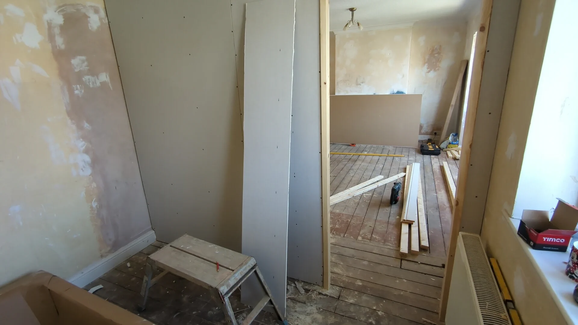 First face of the stud partition wall plasterboarded around the door opening