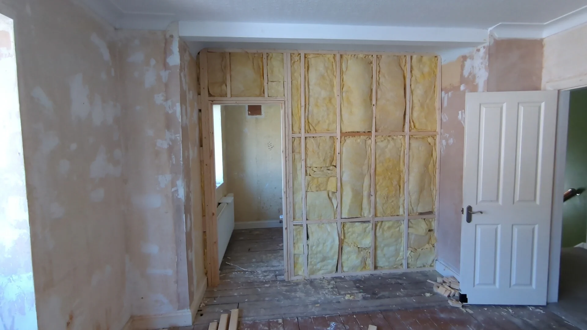 Mineral wool acoustic insulation fitted between the studs of the partition wall