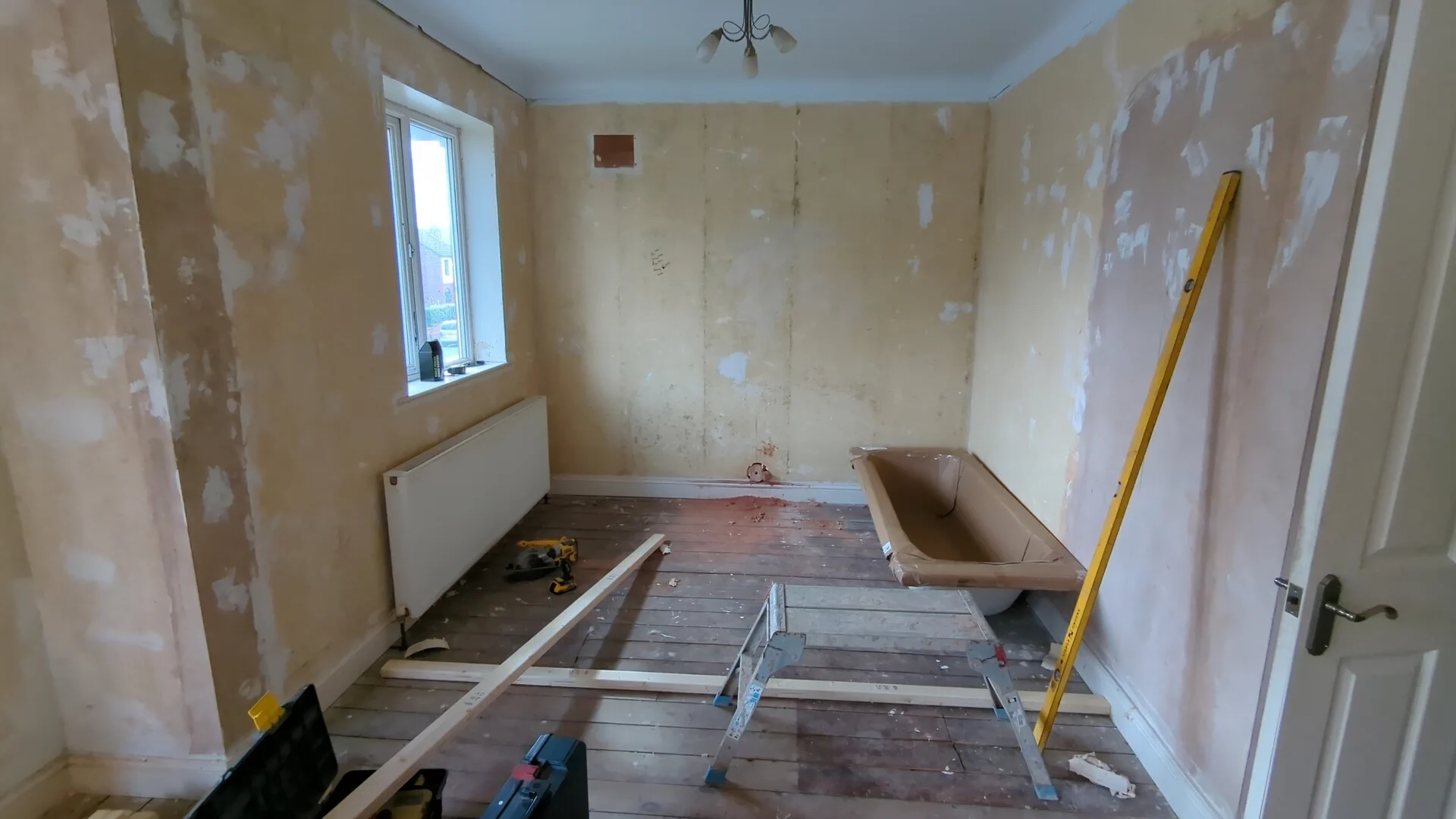 Room marked out with plumb lines for the new stud partition wall position