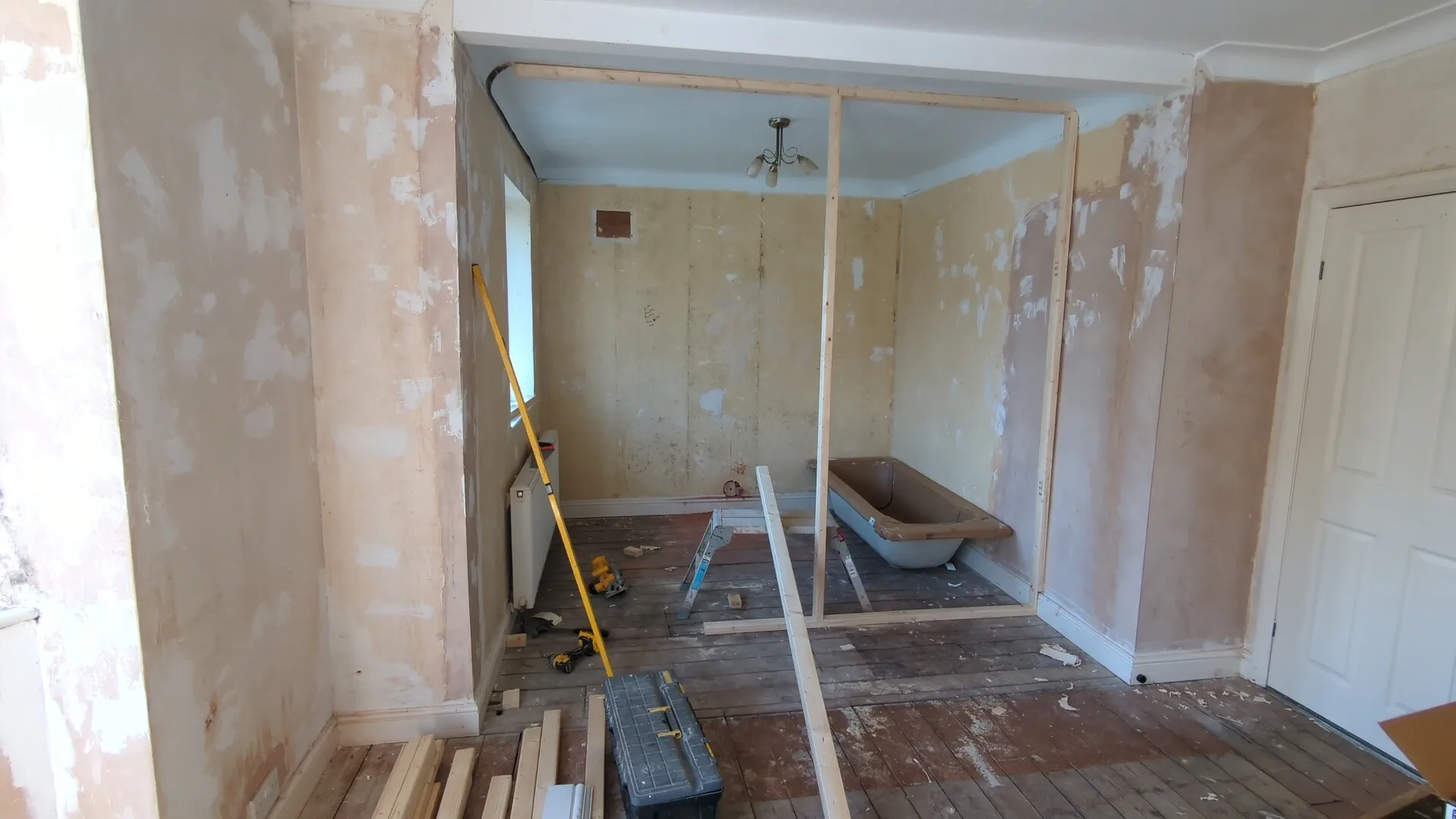 Checking the stud wall frame for plumb and level