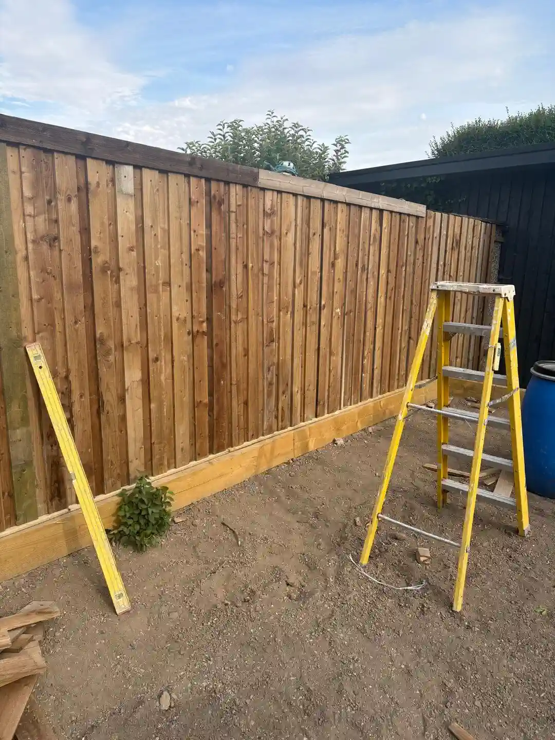Finished vertical timber cladding fitted to a garage wall