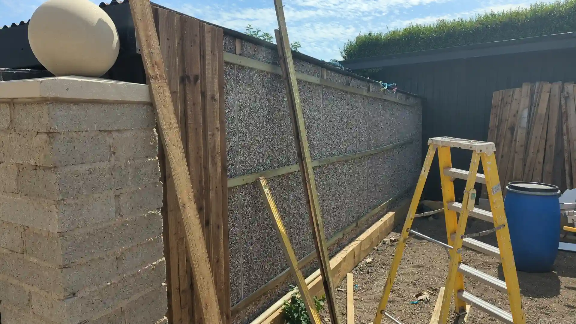 Pressure-treated timber battens fixed to the existing garage wall
