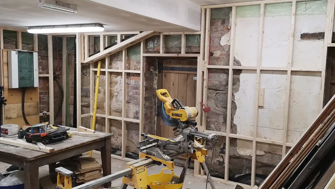New timber studwork and first-fix carpentry forming the kitchen area at The Counting House