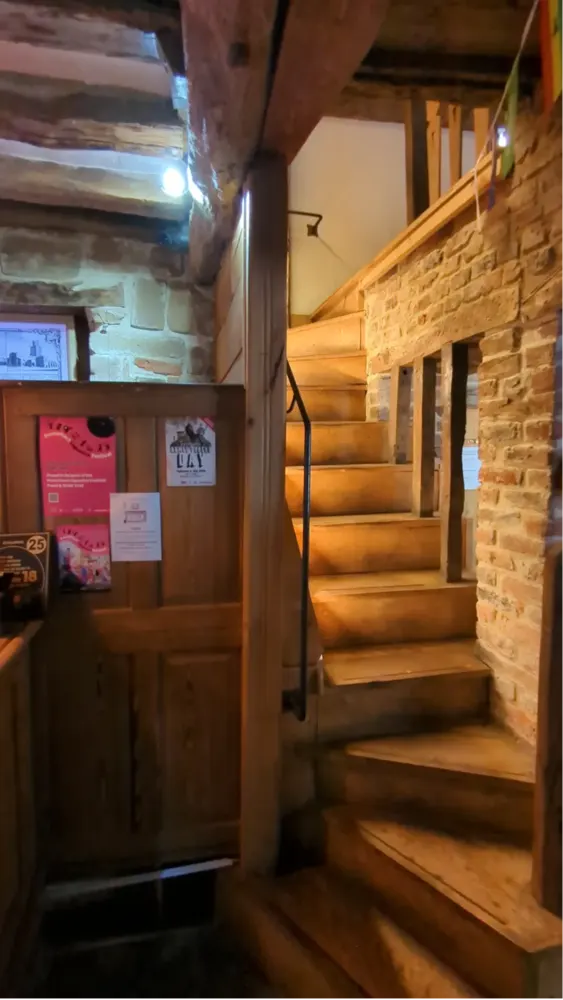 Oak bar stair with shaped and fluted newel post detail at The Counting House