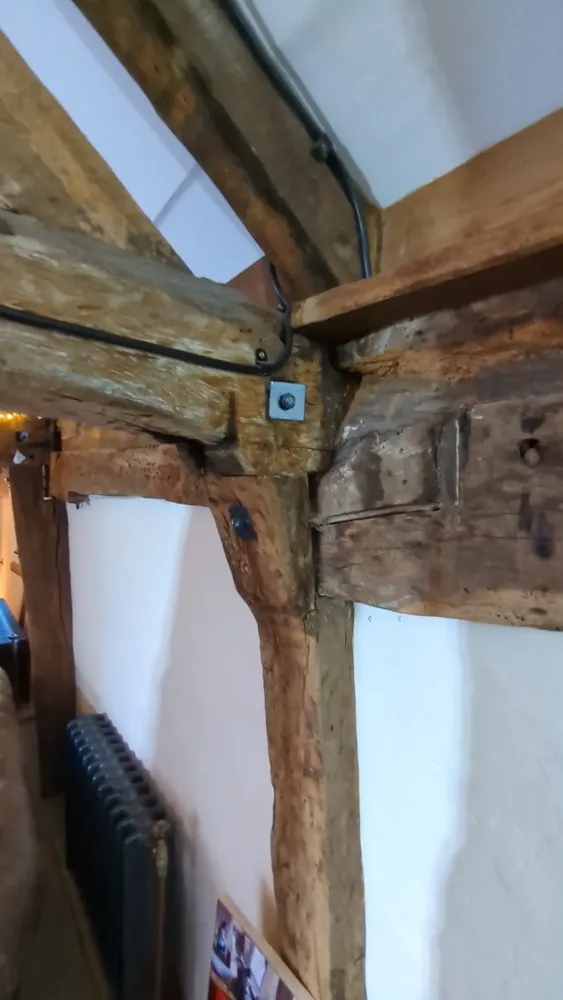 Threaded bar and washer plate securing a repaired oak beam junction at The Counting House