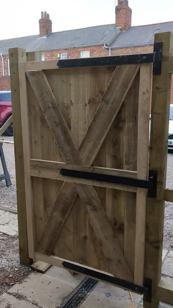 Cross-braced back of the oak-framed gate on black ironmongery at The Counting House
