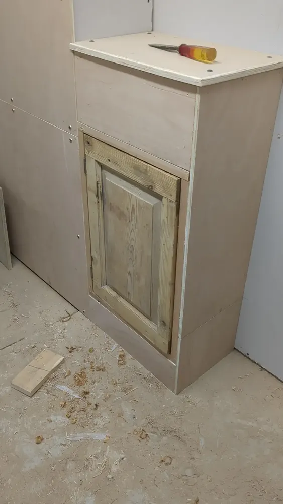 Salvaged Victorian panelled door repurposed as a bespoke boxed-in cupboard front at The Counting House