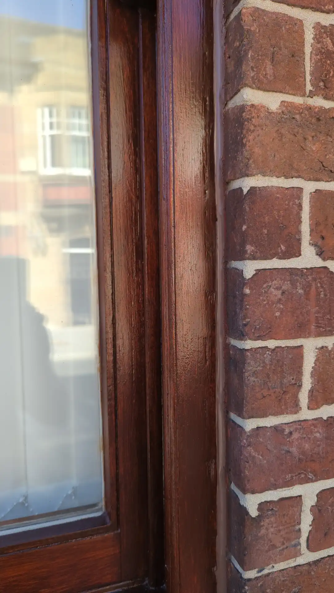 New silicone sealant bead closing the joint between a finished timber window frame and the brickwork in Pontefract