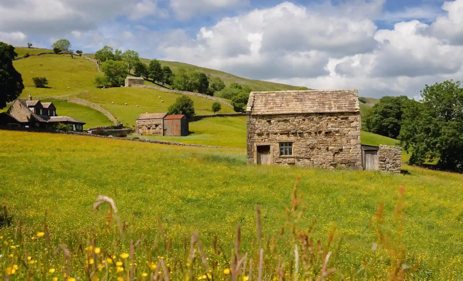 Yorkshire countryside with stone barns and dry stone walls