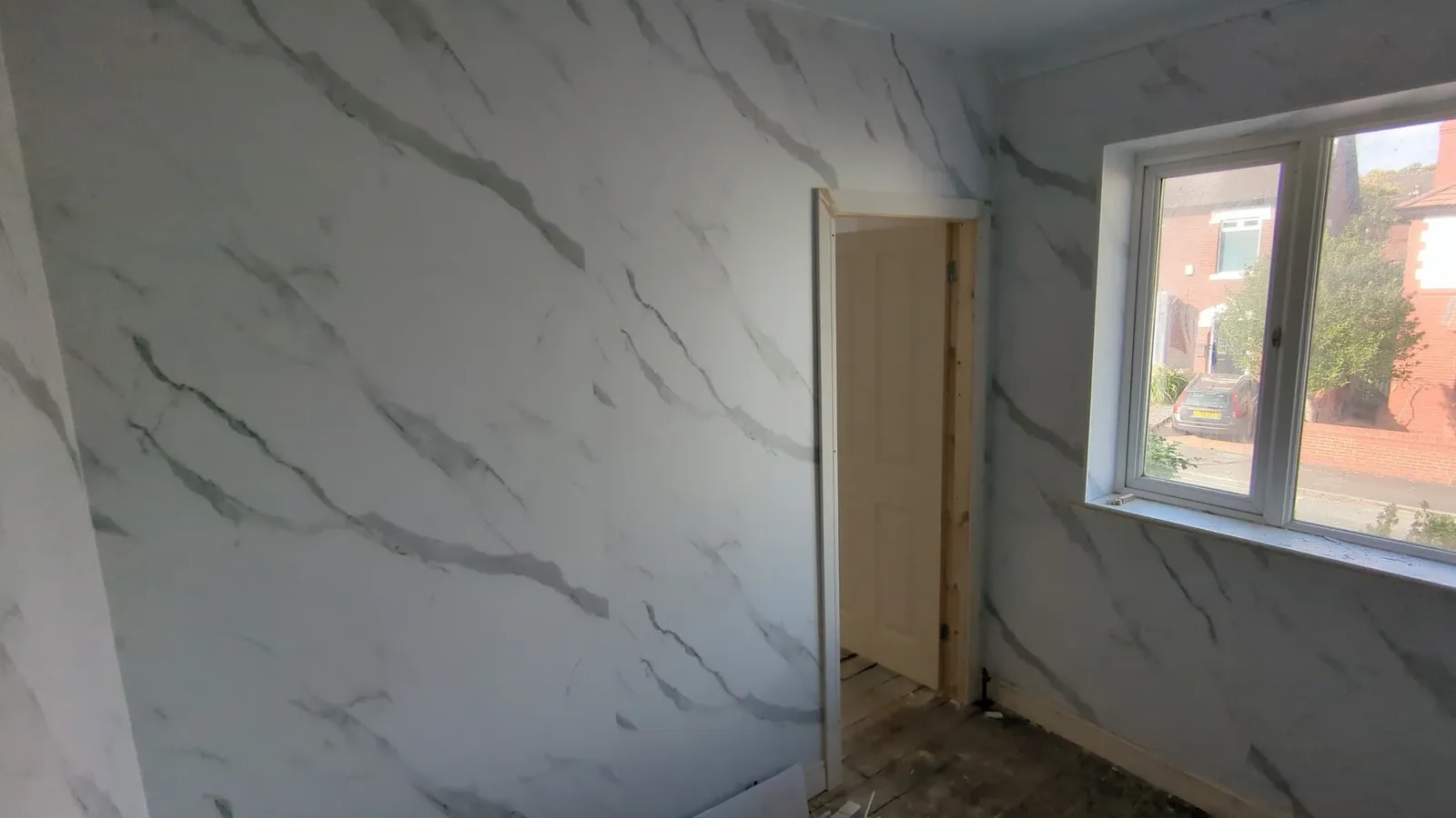 Interlocking wall panelling fitted around a doorway