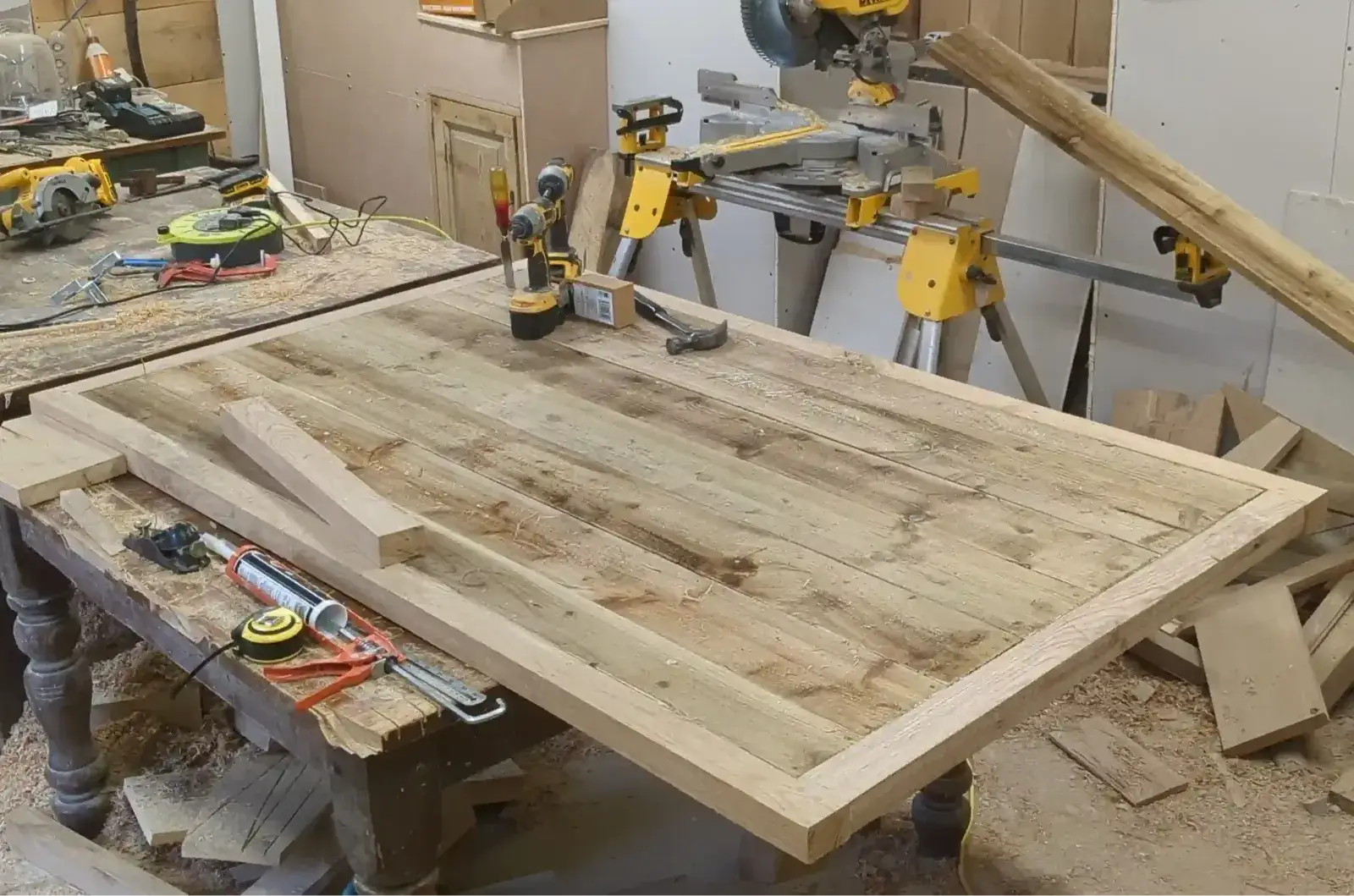 Oak framed and boarded door on the workshop bench with tools to hand