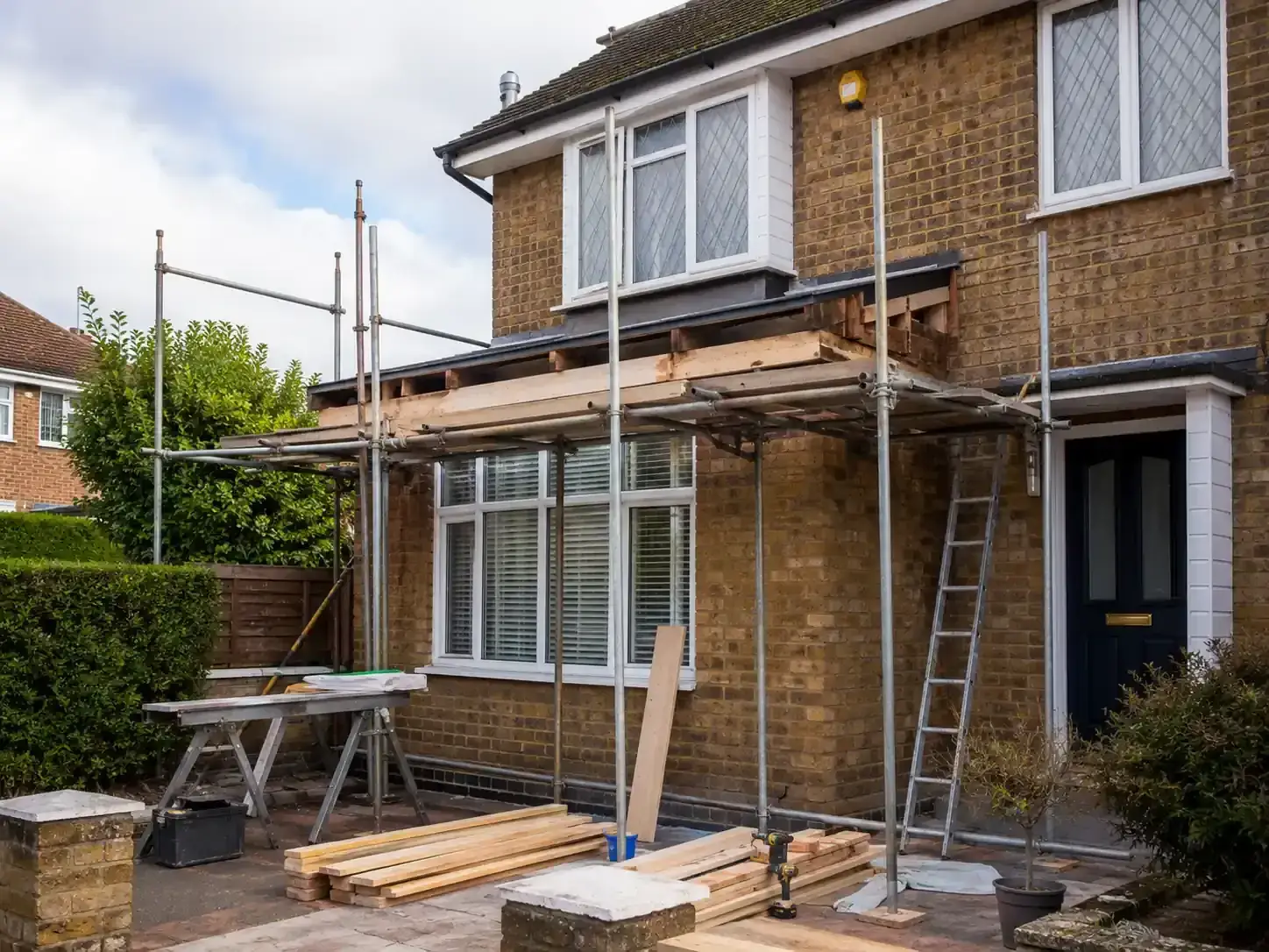 Timber and scaffolding set up for carpentry repair work on a house frontage