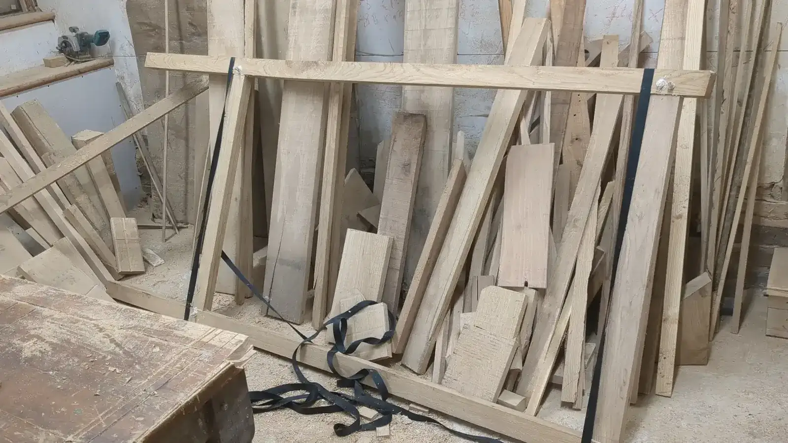 Oak boards and sections stacked in the workshop